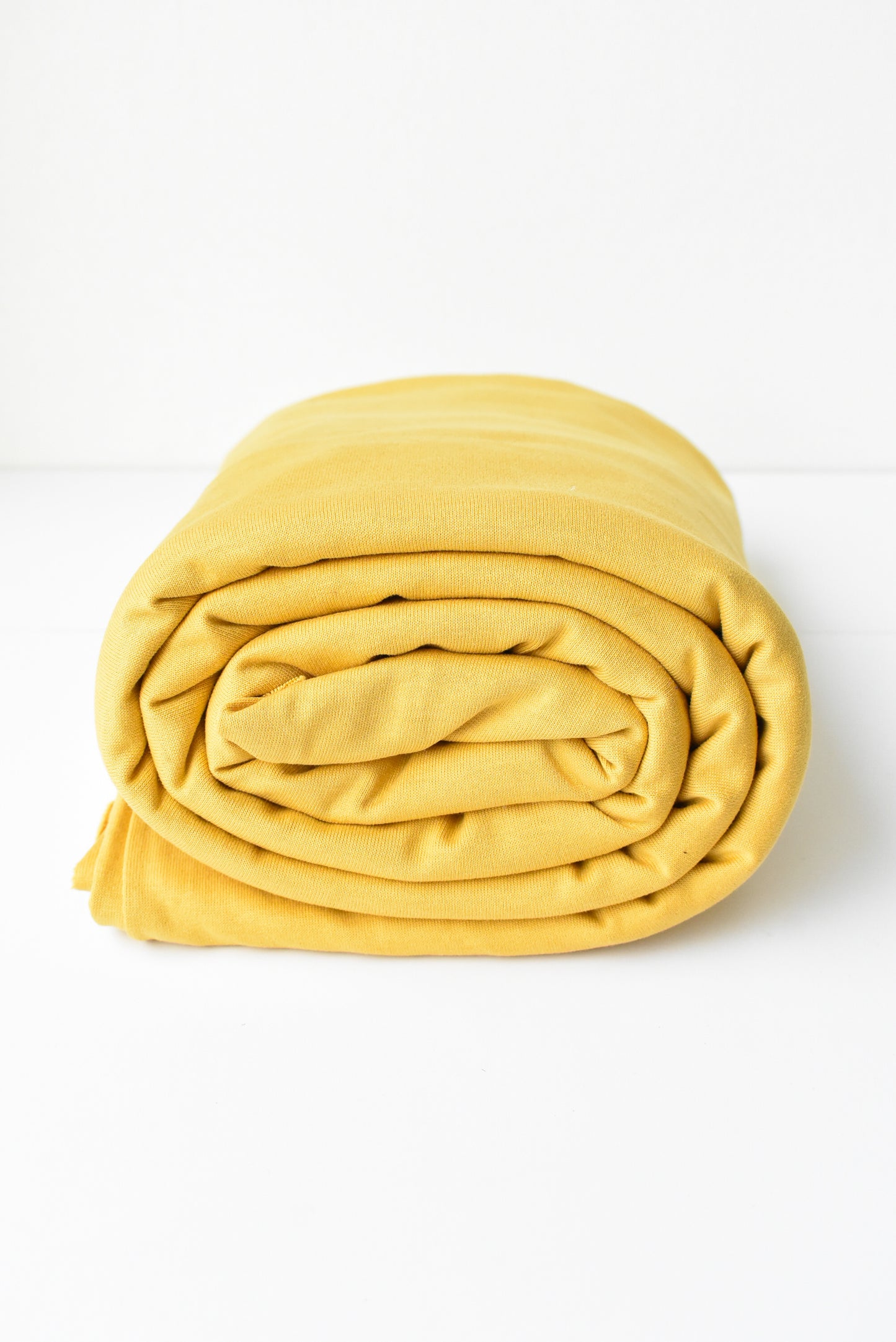 Roll of golden yellow fabric