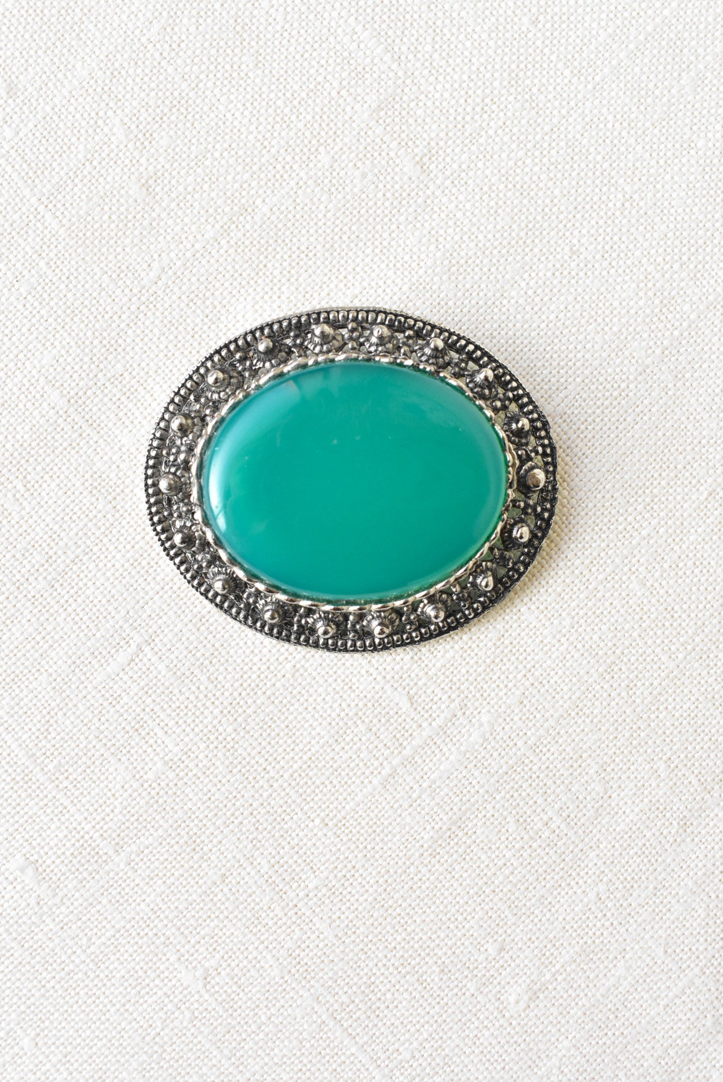 Silver and emerald brooch