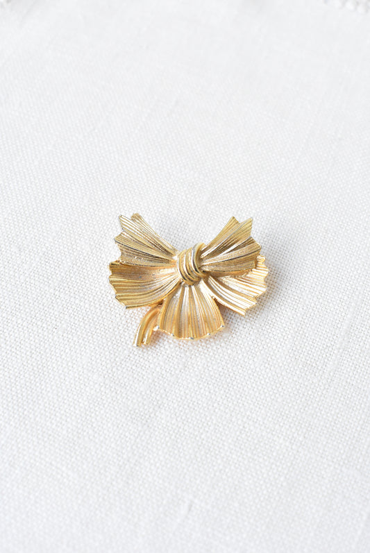 Golden bow brooch