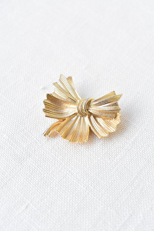 Golden bow brooch