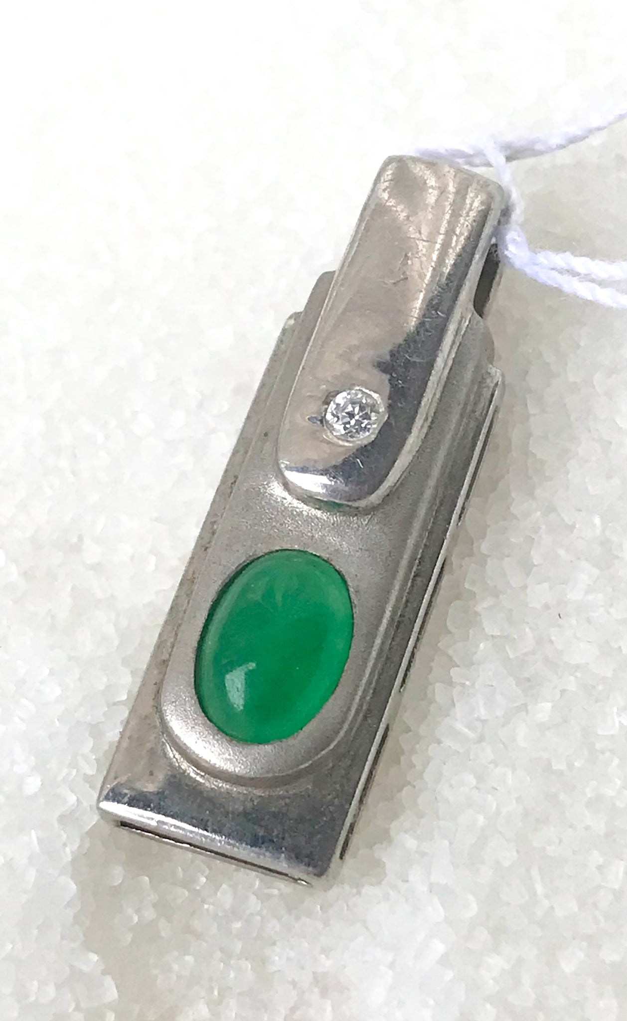 Silver pendant with diamante and green accents