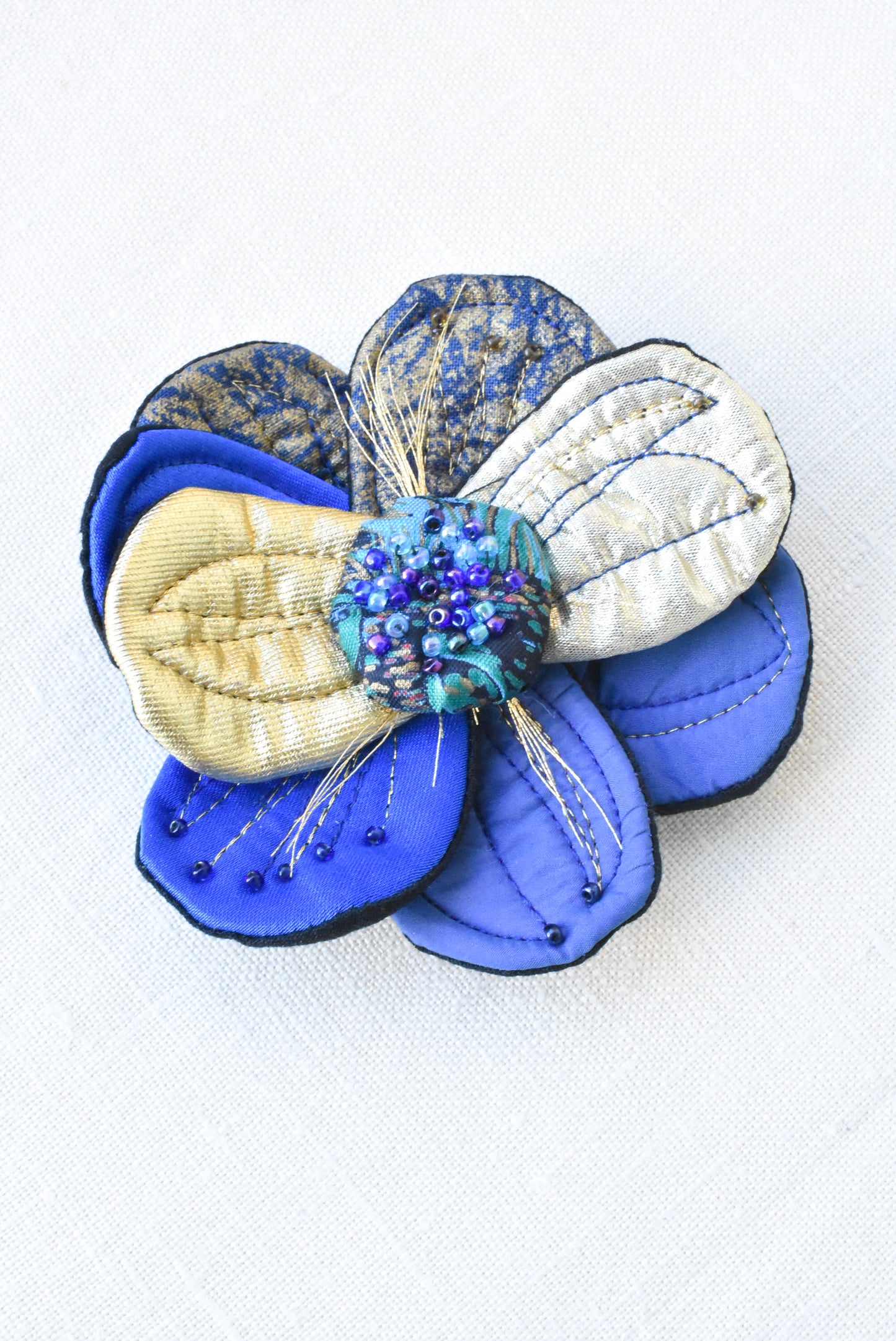 Large blue/gold fabric flower brooch